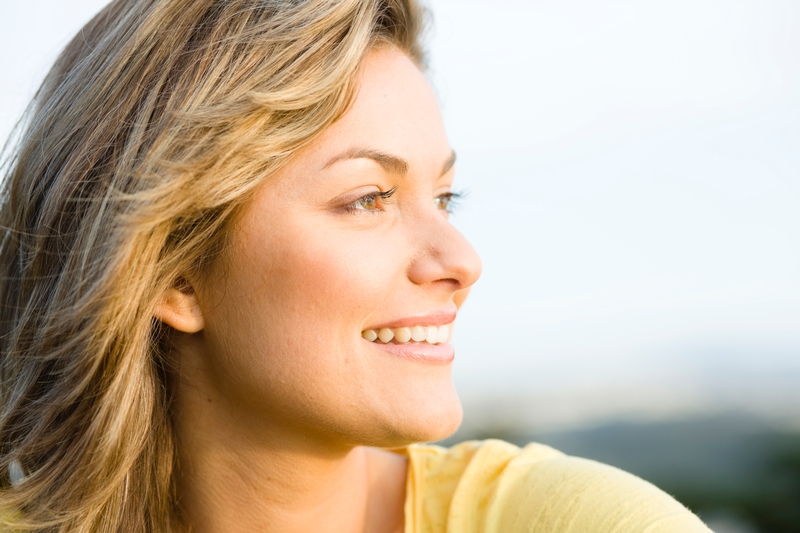 healthy smiling woman looks right, caucasian woman, upbeat woman, changing energy of cells or person or emotions to create health, clearing energy for improved health