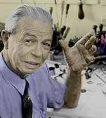 Portrait of medical reseracher and Rife Microscope inventor, Royal Rife, waving at camera from a workbench. His hair is gray here. Was this photo taken in Mexico, where he was forced to flee?